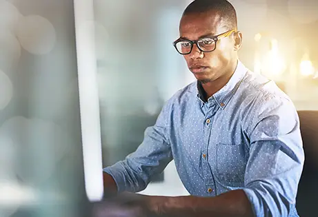 Person on a computer - Mayberry Jamaican Equities